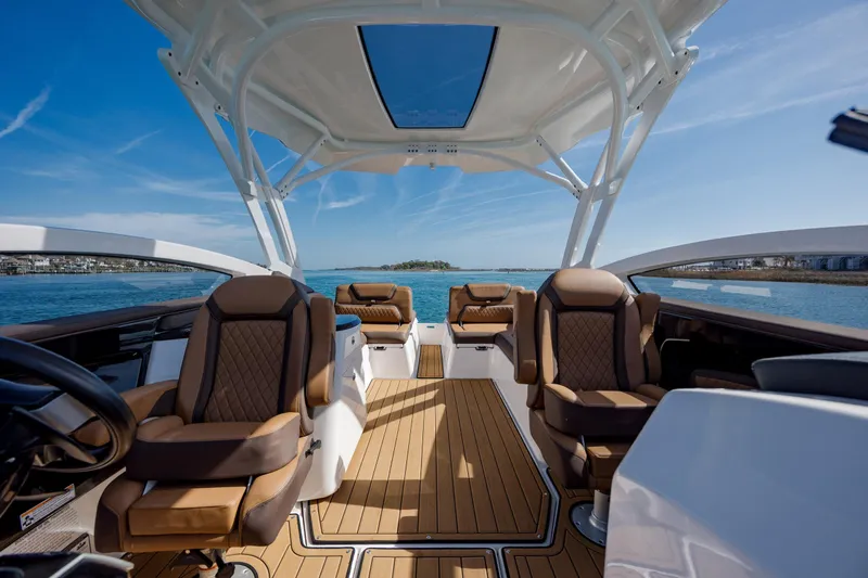 Slide: The Image of 2024 Yamaha Boats 275SD interior with luxurious seating and panoramic water views. - 21