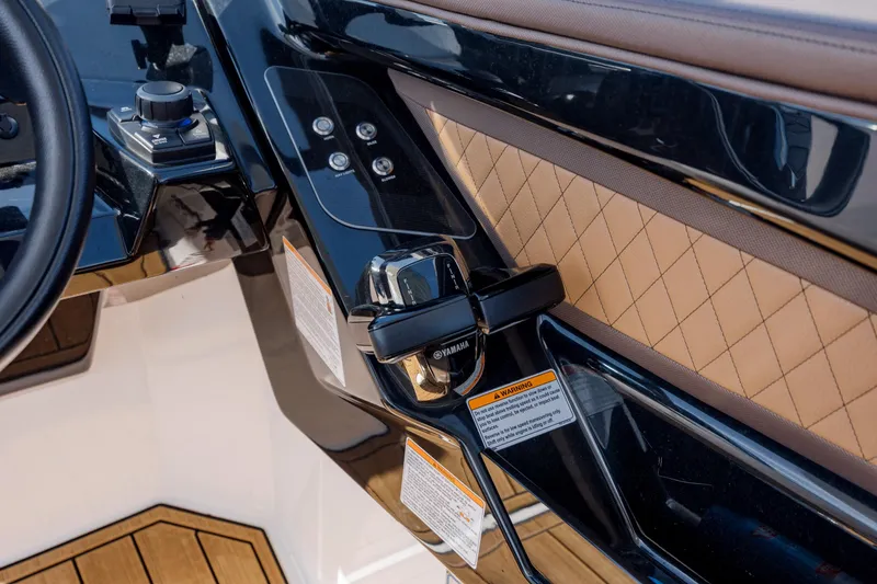 Slide: The Image of 2024 Yamaha Boats 275SD helm with sleek controls and quilted upholstery. - 24