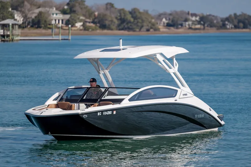 Slide: The Image of 2024 Yamaha Boats 275SD cruising on a serene lake with a scenic backdrop. - 3
