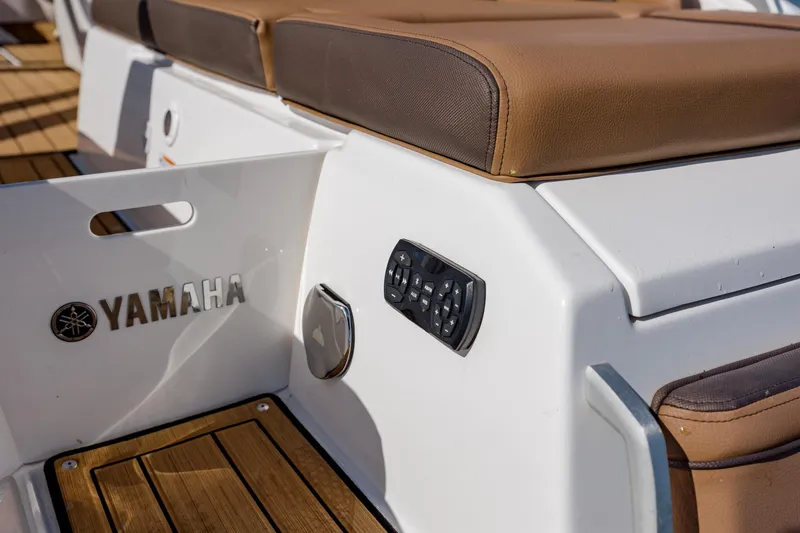 Slide: The Image of 2024 Yamaha Boats 275SD interior detail with brown seating and control panel. - 30