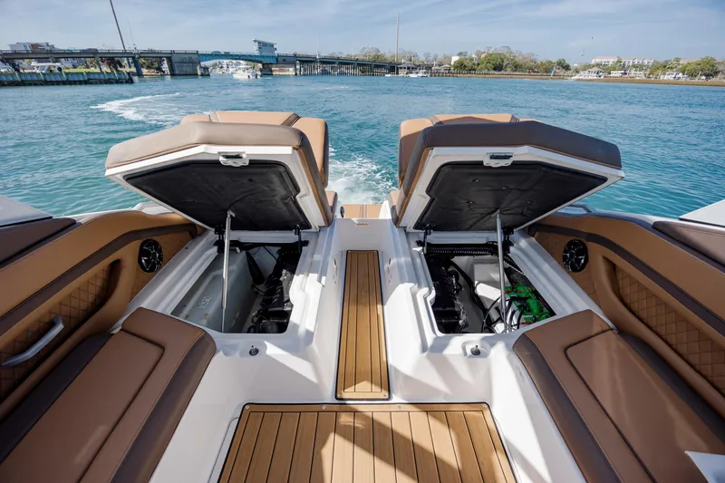 Slide: The Image of 2024 Yamaha Boats 275SD with open storage compartments, showcasing luxurious seating and teak flooring. - 34