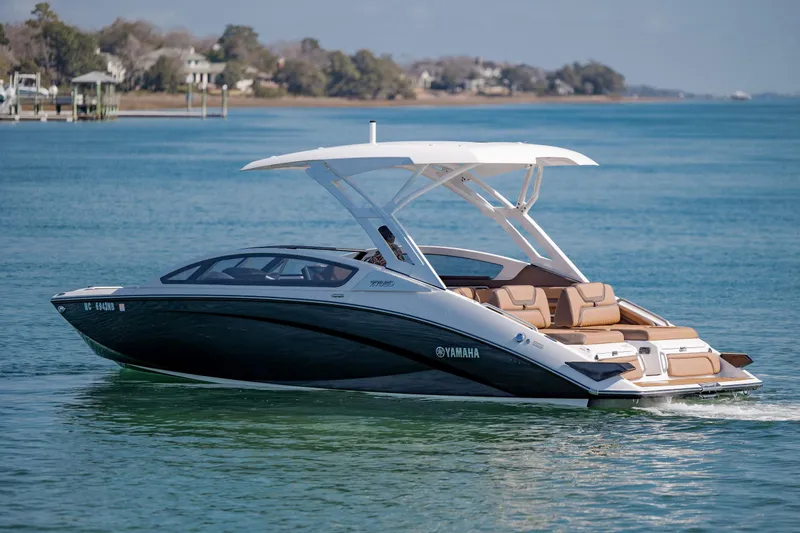 Slide: The Image of 2024 Yamaha Boats 275SD cruising on a serene lake with scenic background. - 4
