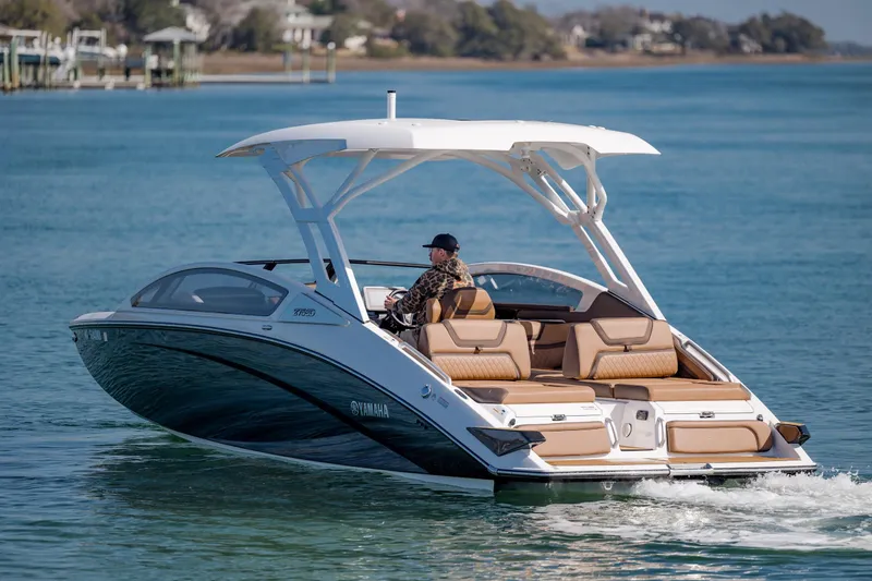Slide: The Image of 2024 Yamaha Boats 275SD cruising on a serene blue lake. - 5