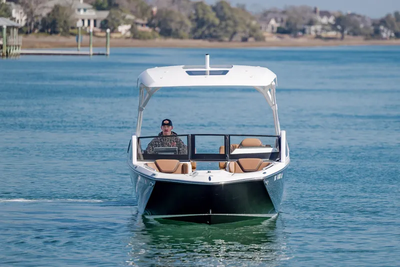 Slide: The Image of 2024 Yamaha Boats 275SD cruising on a serene waterway, showcasing sleek design and luxury. - 6
