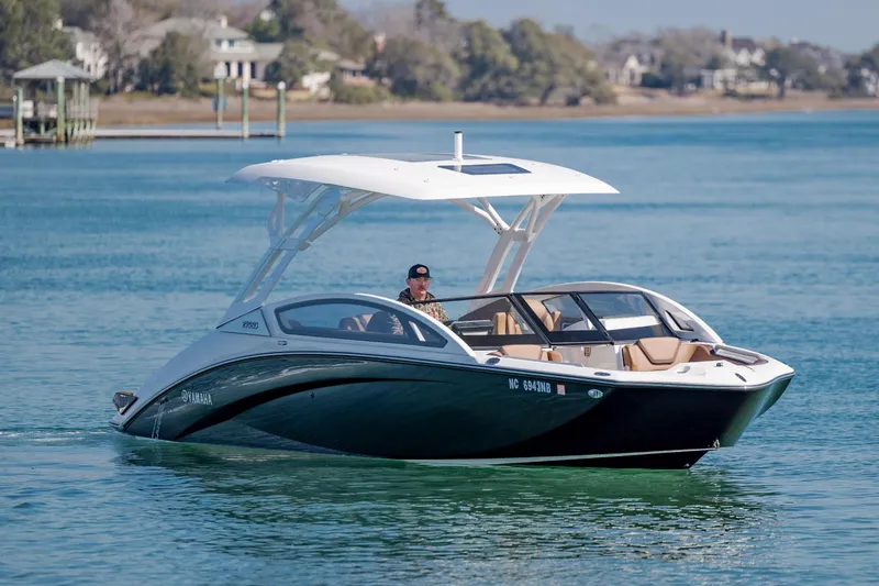 Slide: The Image of 2024 Yamaha Boats 275SD cruising on a serene lake with scenic background. - 7