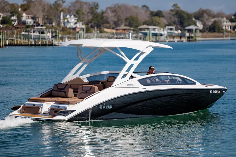 Slide: The Image of 2024 Yamaha Boats 275SD cruising on a serene lake with modern design and sleek features. - 8