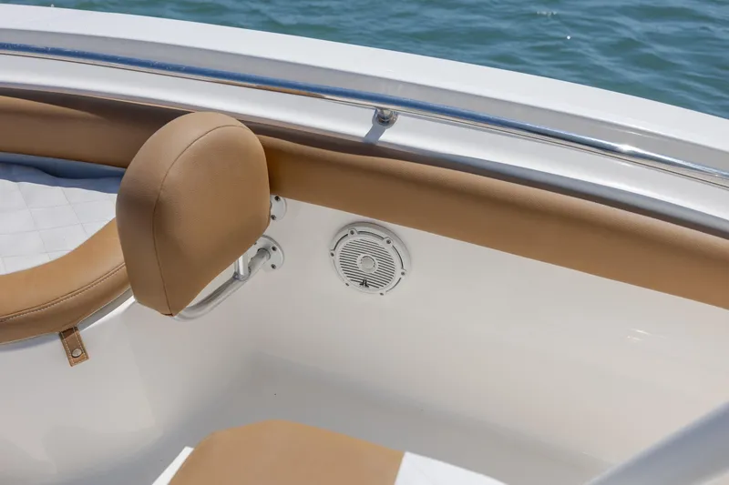 Slide: The Image of 2019 Pioneer 222 Sportfish boat interior with tan seating and speaker detail. - 13