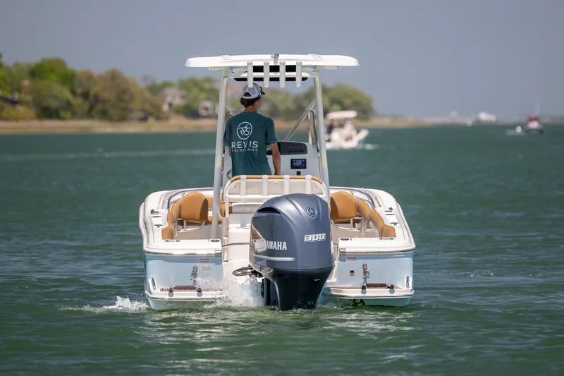 Slide: The Image of 2019 Pioneer 222 Sportfish boat cruising on a calm waterway with Yamaha engine. - 5