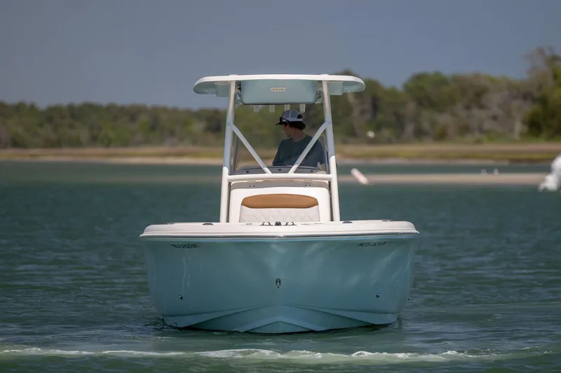 Slide: The Image of 2019 Pioneer 222 Sportfish boat cruising on calm water with scenic background. - 8