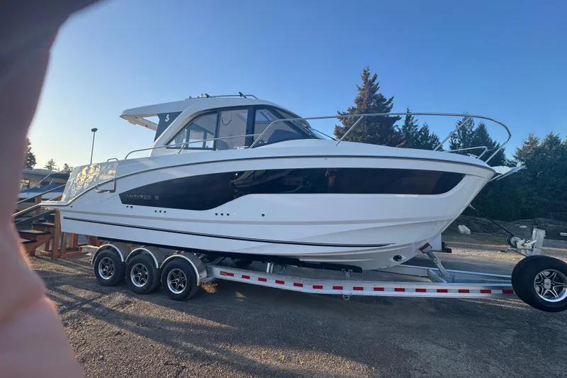 The Image of 2026 Beneteau Antares 9 V2 boat on trailer, parked outdoors. - 1