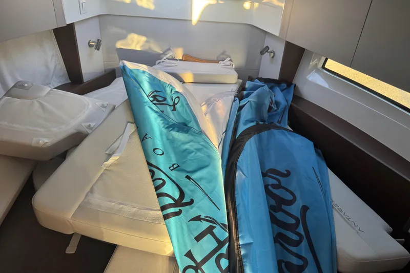 Slide: The Image of Interior of 2026 Beneteau Antares 9 V2 with cushions and blue cover. - 5