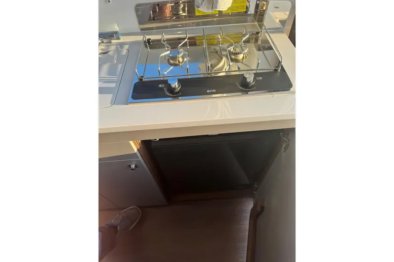 Slide: The Image of Compact kitchen area in the 2026 Beneteau Antares 9 V2 with a modern stove. - 8