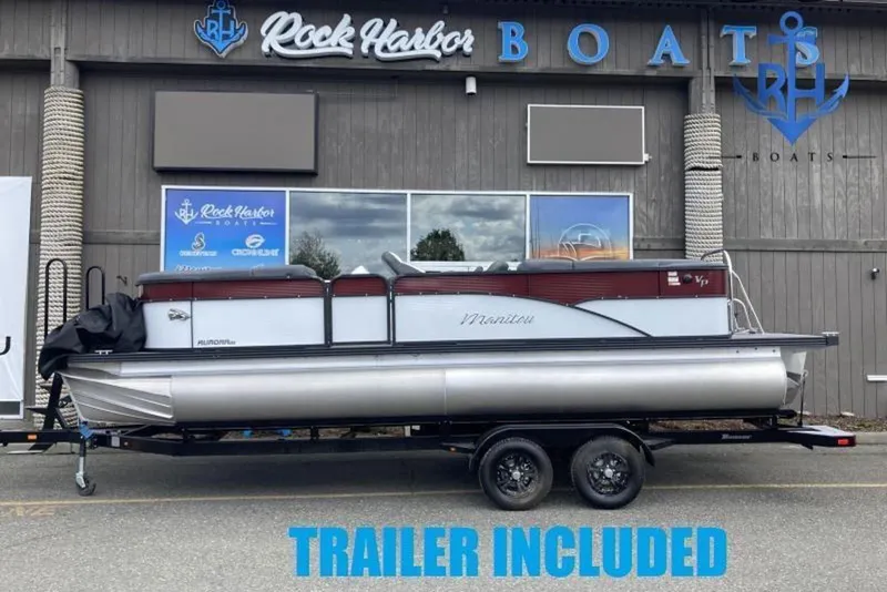 The Image of 2022 Manitou 23 Aurora pontoon boat with trailer at Rock Harbor Boats dealership. - 1