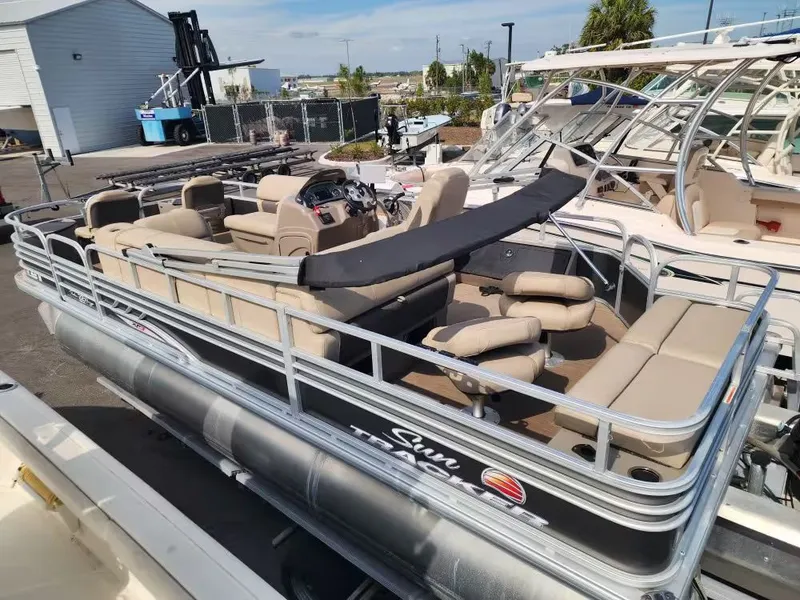 Slide: The Image of 2022 Sun Tracker 22 DLX pontoon boat with beige seating at the dock. - 12