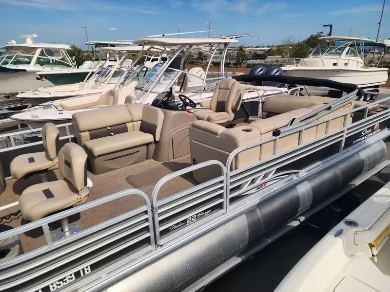 Slide: The Image of 2022 Sun Tracker 22 DLX pontoon boat docked at marina. - 13