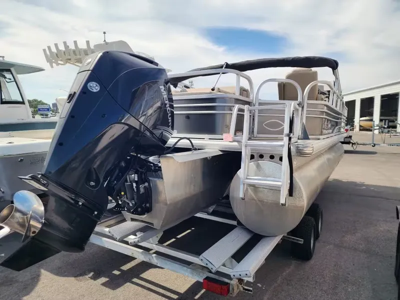 Slide: The Image of 2022 Sun Tracker 22 DLX pontoon boat with outboard motor on trailer. - 5