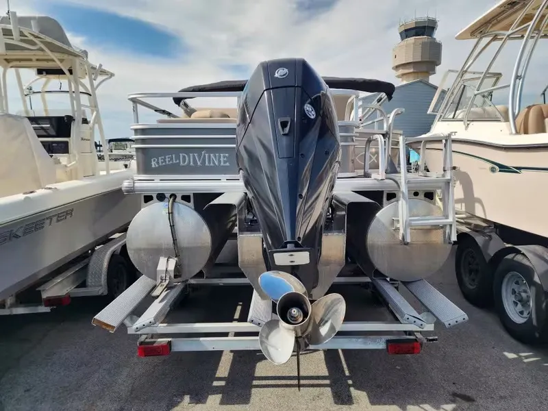 Slide: The Image of 2022 Sun Tracker 22 DLX pontoon boat with outboard motor. - 6