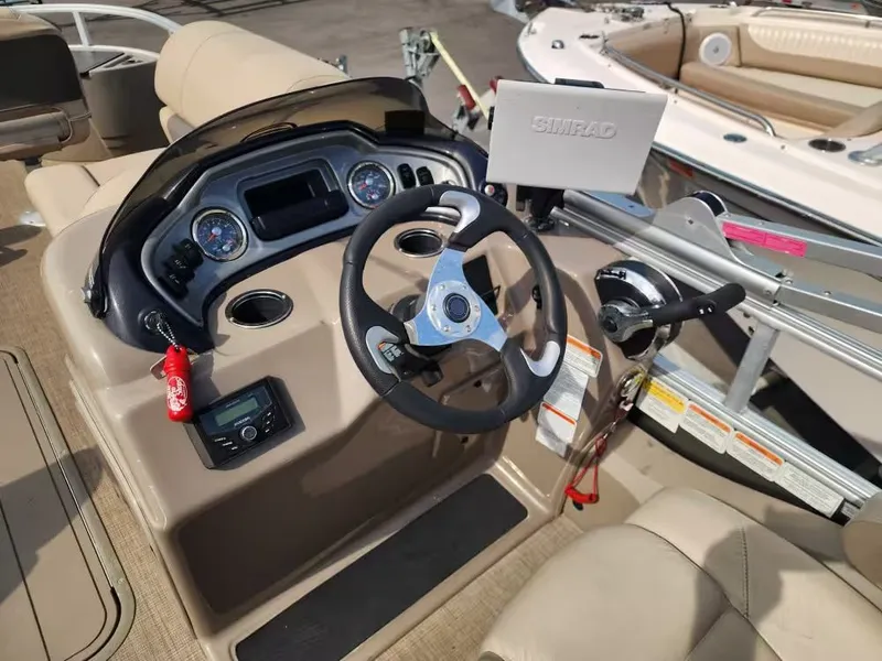 Slide: The Image of Interior view of Sun Tracker 22 DLX 2022 helm with Simrad display. - 9
