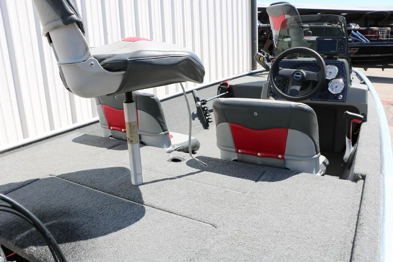 Slide: The Image of 2014 Bass Tracker Pro 16 boat interior with seating and steering console. - 14