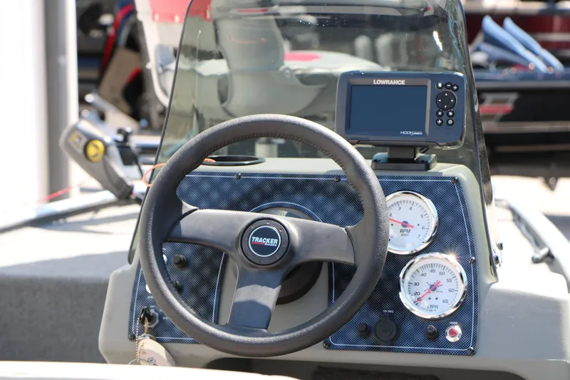 Slide: The Image of 2014 Bass Tracker Pro 16 dashboard with steering wheel and Lowrance fishfinder. - 15