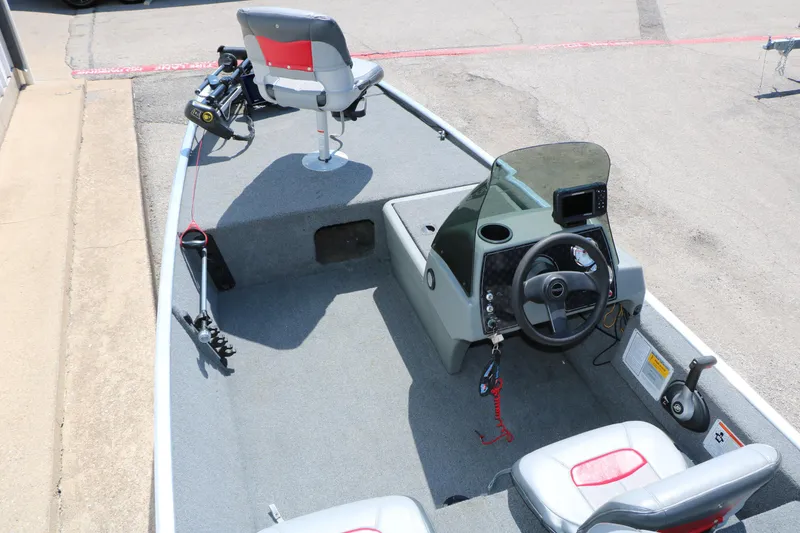 Slide: The Image of 2014 Bass Tracker Pro 16 boat interior with steering console and seating. - 17