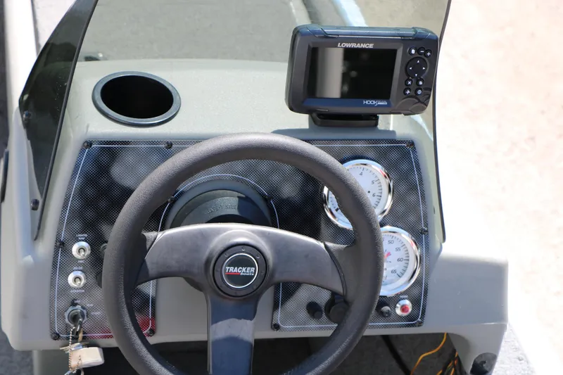 Slide: The Image of 2014 Bass Tracker Pro 16 dashboard with steering wheel and Lowrance fish finder. - 27