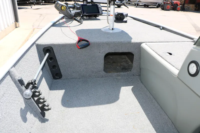 Slide: The Image of 2014 Bass Tracker Pro 16 boat interior with fishing rod holders and control panel. - 30