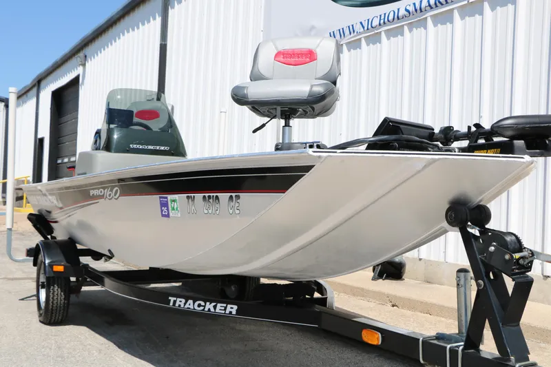 Slide: The Image of 2014 Bass Tracker Pro 16 boat on trailer, parked outside a building. - 4