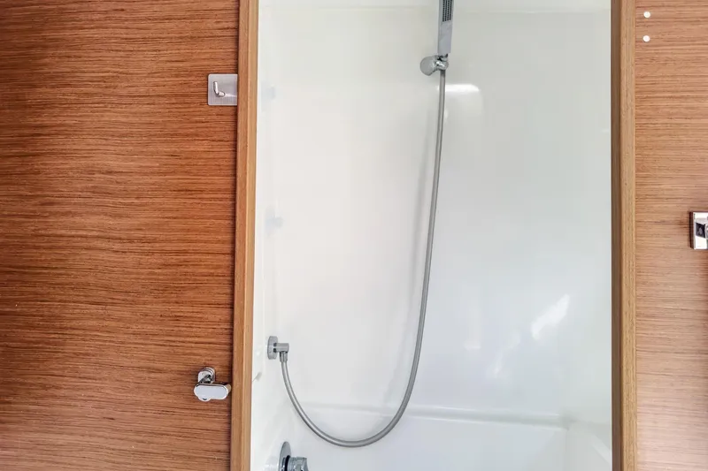 Slide: The Image of Shower area in 2020 Lagoon 42 yacht with wooden paneling and modern fixtures. - 54