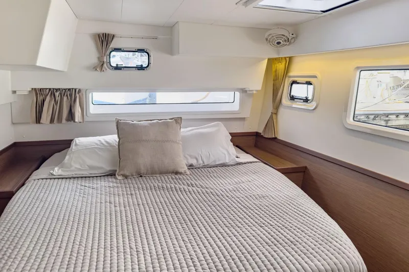 Slide: The Image of Cozy cabin interior of 2020 Lagoon 42 catamaran with comfortable bedding and natural light. - 56
