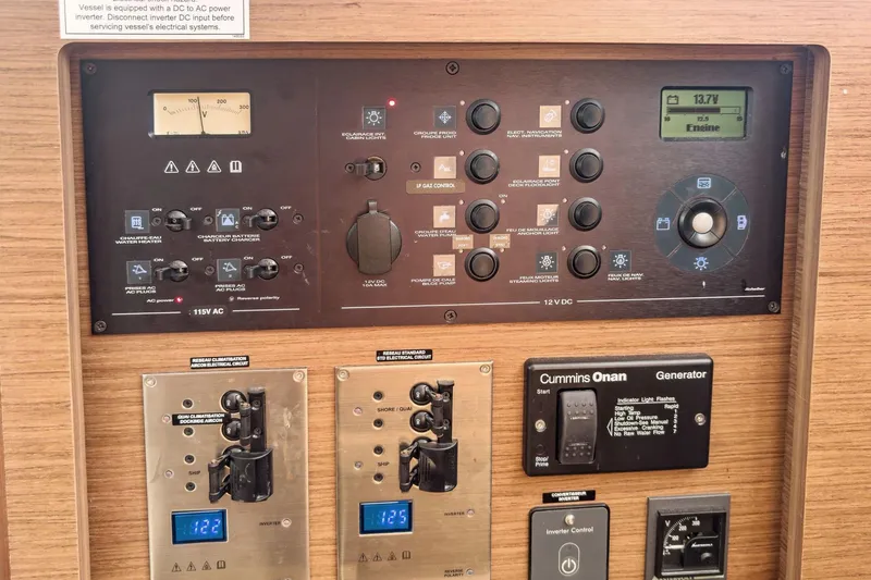 Slide: The Image of Electrical control panel of a 2020 Lagoon 42 catamaran, featuring various switches and gauges. - 61