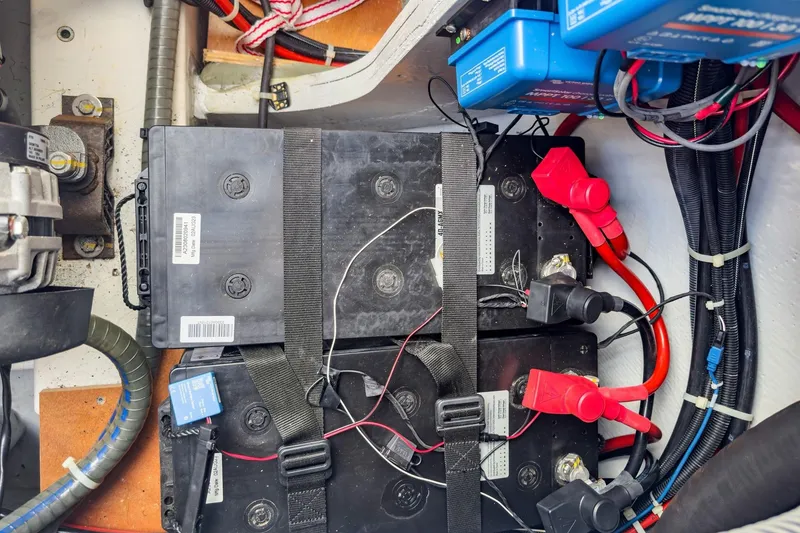 Slide: The Image of Battery compartment of a 2020 Lagoon 42 yacht, featuring wiring and connectors. - 84