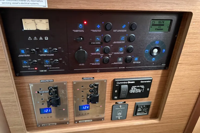 Slide: The Image of Electrical control panel of a 2020 Lagoon 42 catamaran with various switches and displays. - 99