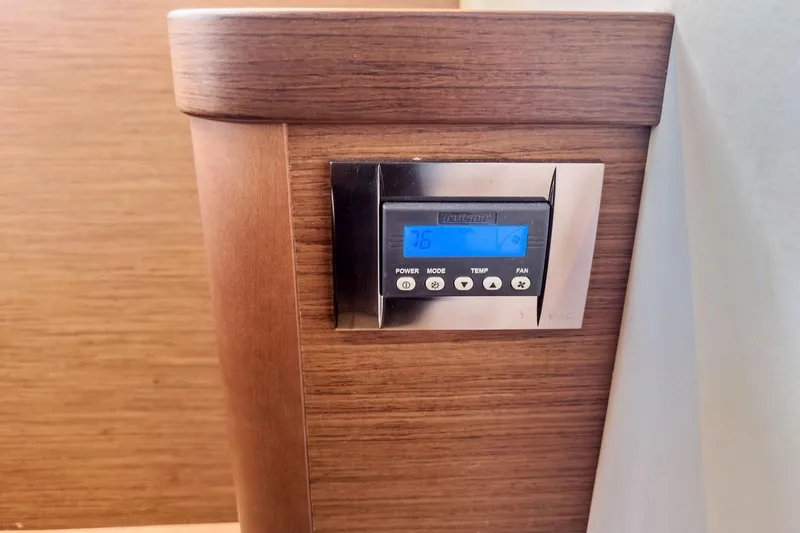 Slide: The Image of Thermostat control panel on 2020 Lagoon 42 yacht with wooden interior. - 55