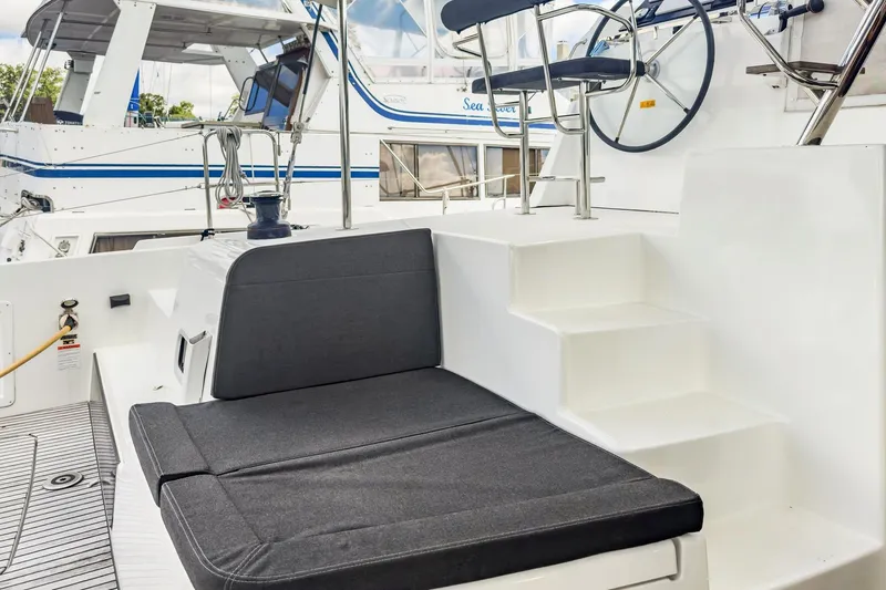 Slide: The Image of Cockpit seating and helm of 2020 Lagoon 42 catamaran, featuring modern design and comfort. - 9