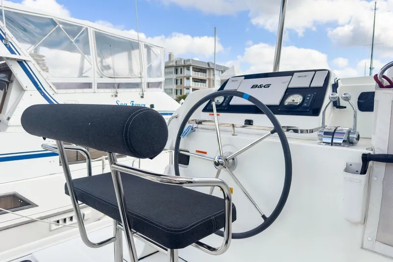Slide: The Image of Helm of 2020 Lagoon 42 catamaran with steering wheel and navigation controls. - 10