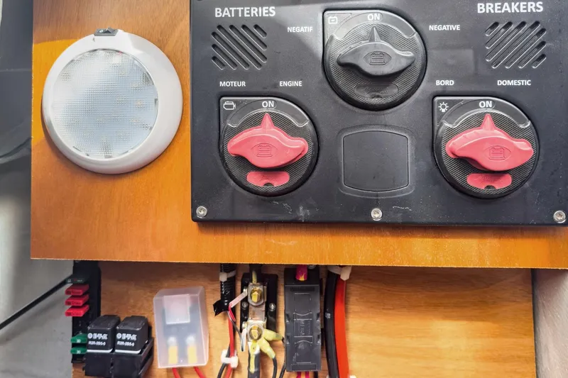 Slide: The Image of Electrical panel of a 2020 Lagoon 42 yacht with battery switches and breakers. - 65