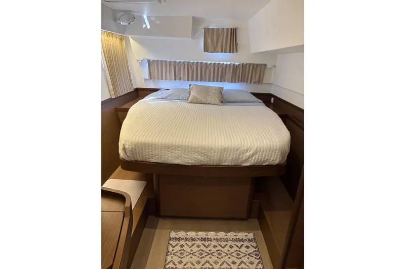 Slide: The Image of Cozy bedroom interior of 2020 Lagoon 42 yacht with elegant wood finish. - 101
