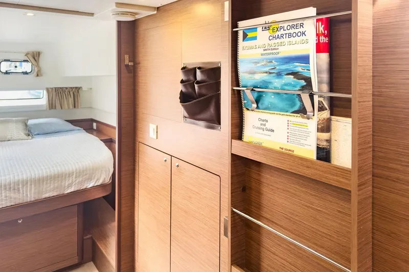 Slide: The Image of Interior of 2020 Lagoon 42 yacht with cozy bedroom and navigation chartbook. - 45