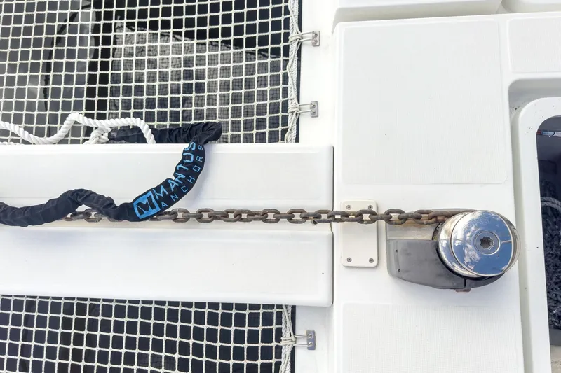 Slide: The Image of Anchor chain and winch on 2020 Lagoon 42 catamaran deck. - 16