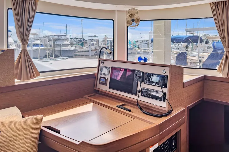 Slide: The Image of Interior of 2020 Lagoon 42 yacht with navigation equipment and marina view. - 39