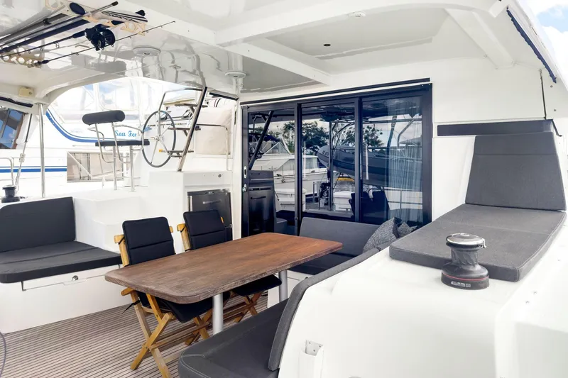 Slide: The Image of Spacious 2020 Lagoon 42 yacht interior with seating, table, and helm station. - 6
