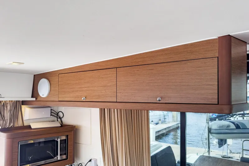 Slide: The Image of Interior of 2020 Lagoon 42 yacht with wooden cabinets and modern appliances. - 29