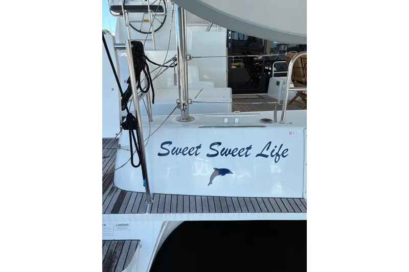 Slide: The Image of Lagoon 42 catamaran, 2020 model, named "Sweet Sweet Life" with dolphin graphic. - 102