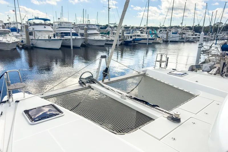 Slide: The Image of 2020 Lagoon 42 catamaran docked in a marina with other boats. - 15