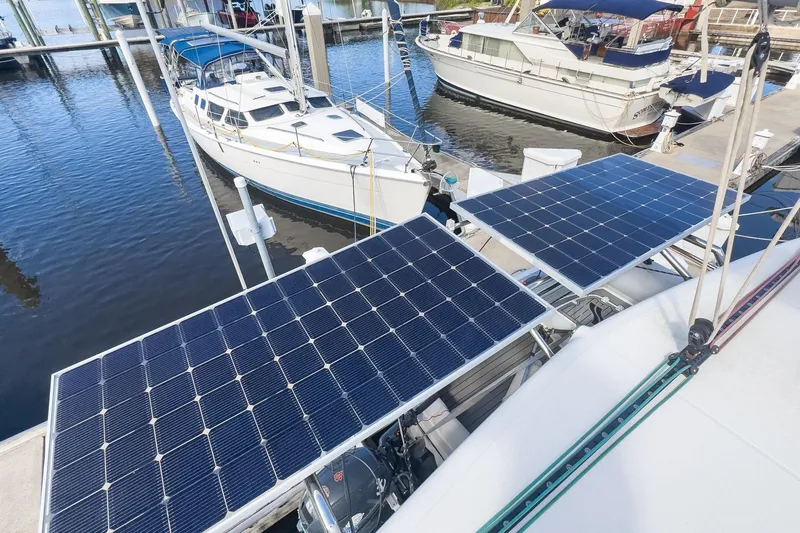 Slide: The Image of 2020 Lagoon 42 catamaran with solar panels docked at marina. - 5