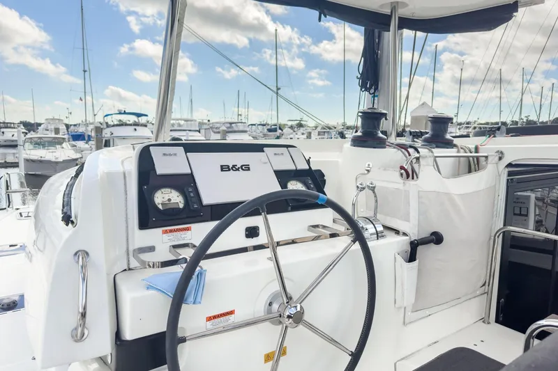 Slide: The Image of Helm of 2020 Lagoon 42 catamaran with B&G navigation system, docked at marina. - 11