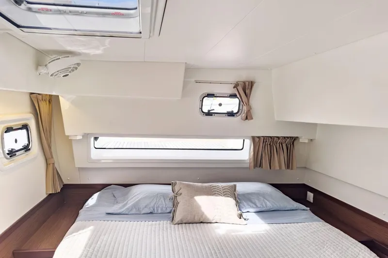 Slide: The Image of Luxurious cabin interior of 2020 Lagoon 42 catamaran with cozy bedding and natural light. - 47