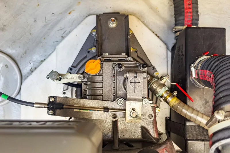 Slide: The Image of Engine compartment of a 2020 Lagoon 42 catamaran, showcasing mechanical components and hoses. - 64