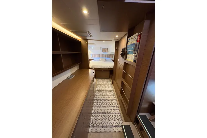 Slide: The Image of Interior of 2020 Lagoon 42 yacht cabin with modern wood finish and cozy bed. - 98